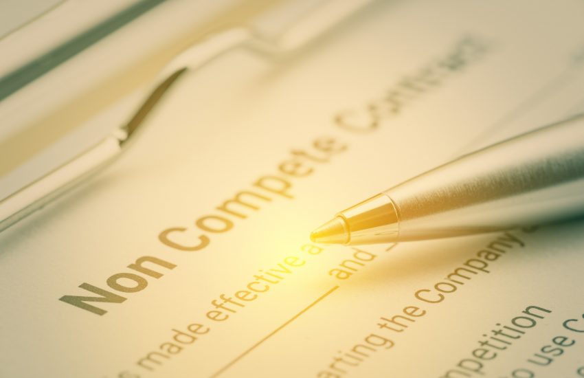 Legal form concept : Blue pen and a non compete contract on a clipboard. Noncompete contract is an agreement between employee and employer, not to enter into competition in subsequence business effort