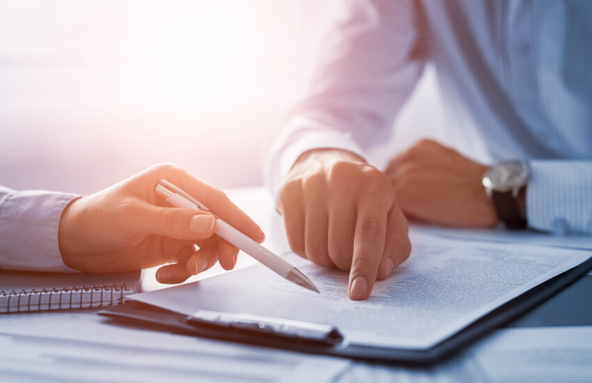 Business people negotiating a contract.